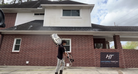 Parking Lot Cleaning 2 Josh from HydroTech holding surface cleaner Houston TX
